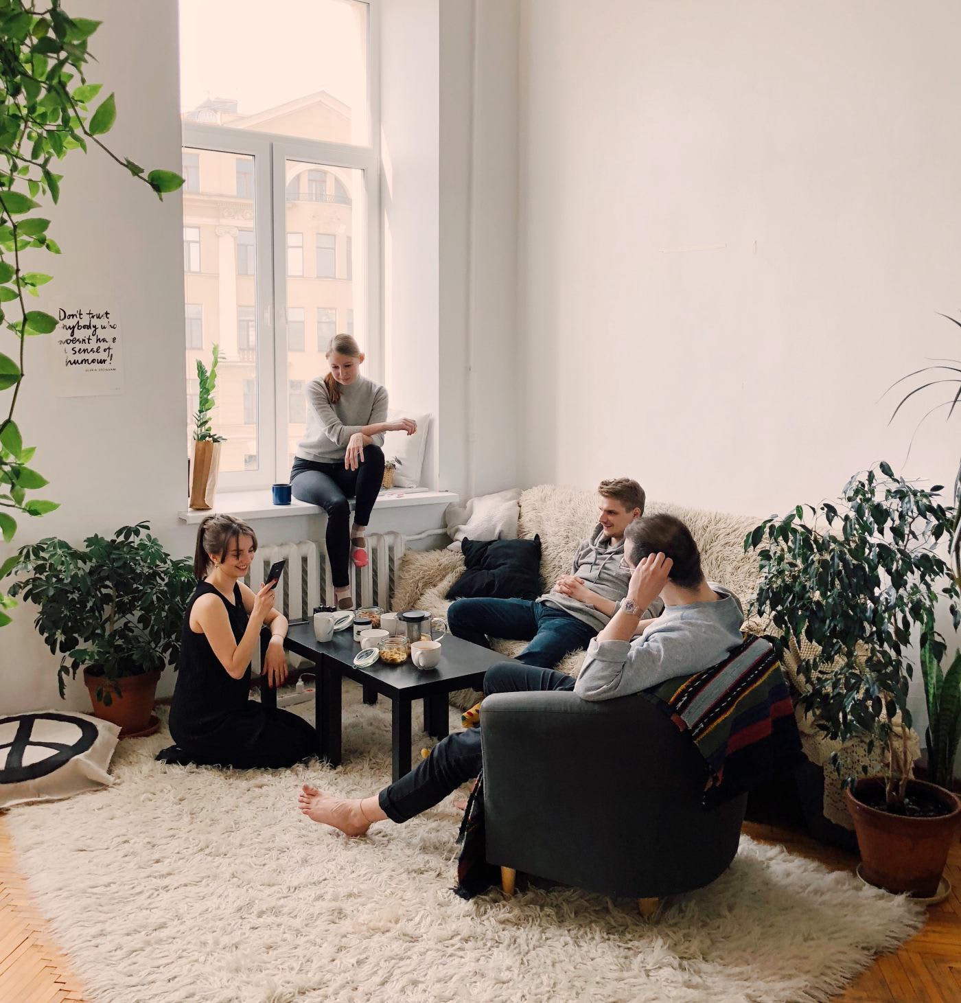 stylish apartment with a group of friends around a coffee table