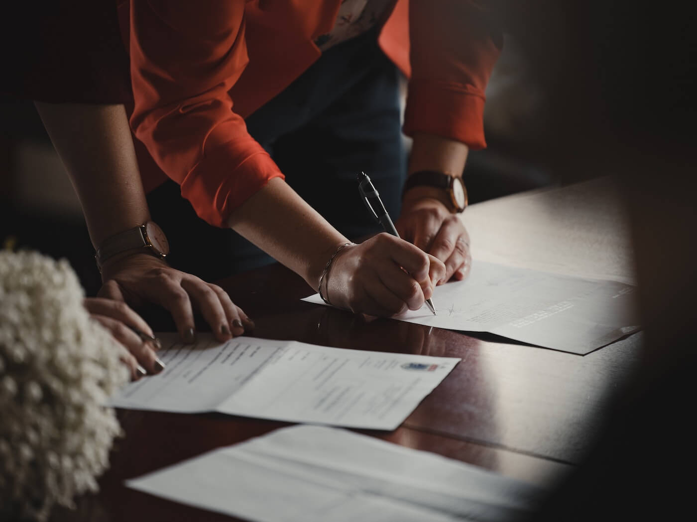 two people review and sign documents