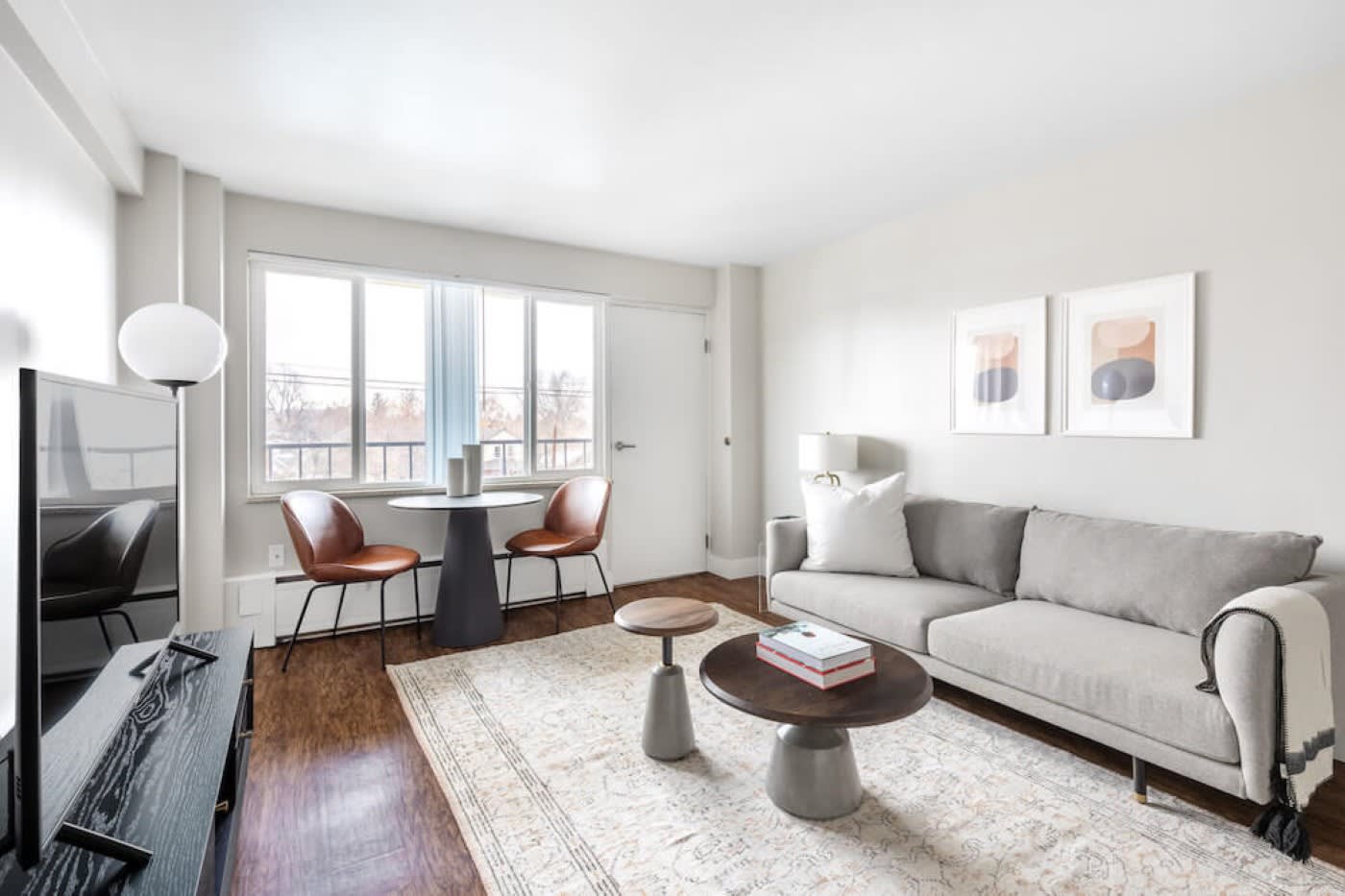 A furnished living room with white furniture