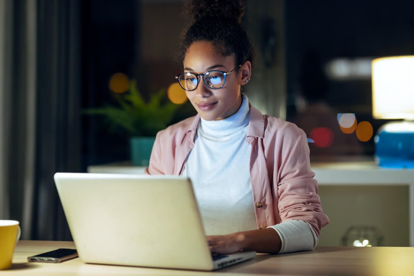 A woman is working on her computer