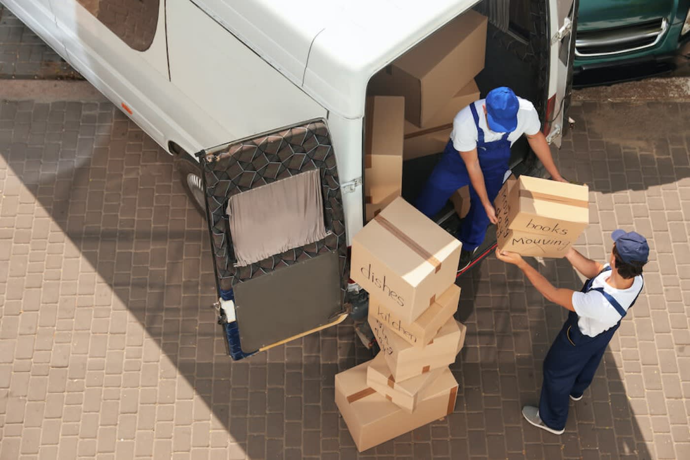 2 movers loading boxes on the truck