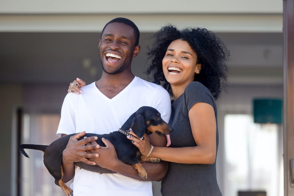 two people move with a pet