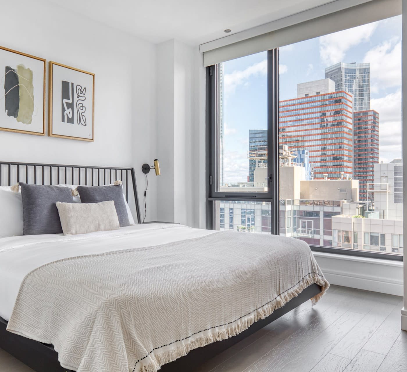 temporary housing NYC calm bedroom with large windows and a city view