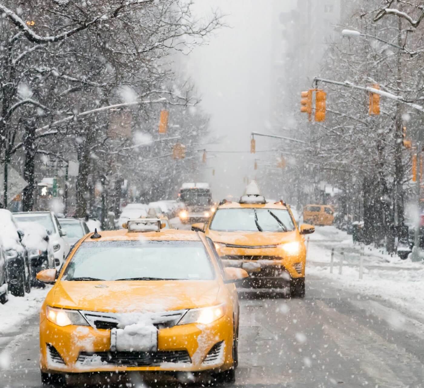 snow falling in nyc, cabs on the road