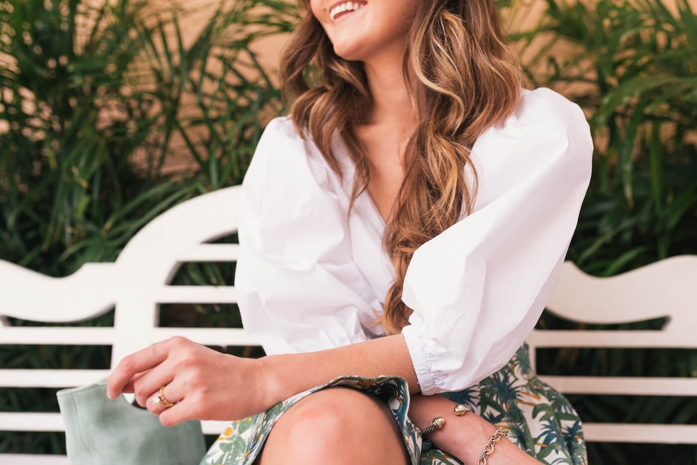 a woman sits on a bench in florida