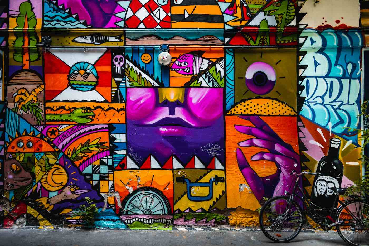 a mural in central berlin with a bicycle in the foreground