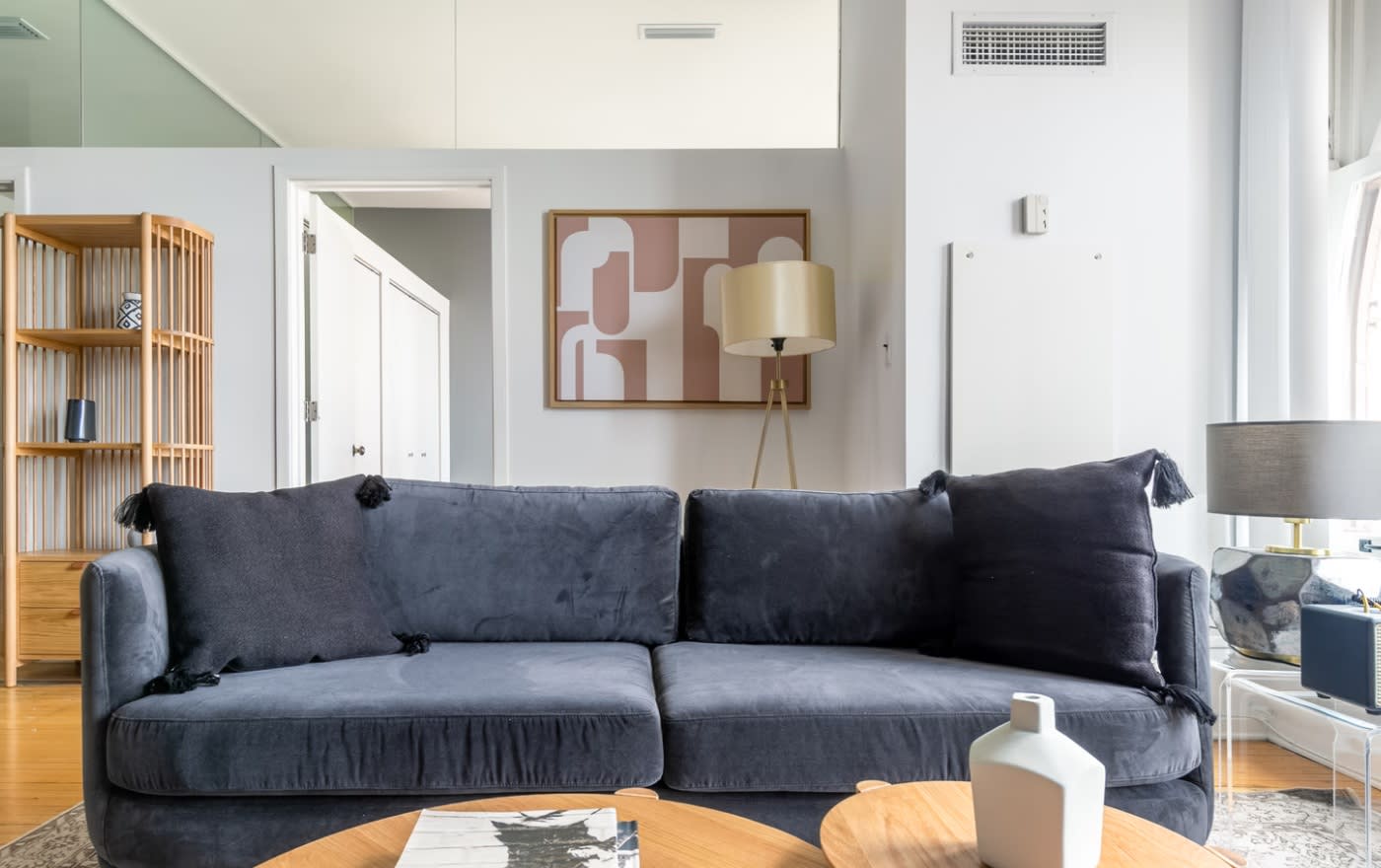 furnished living room chicago - blue velvet couch with earth toned coffee table