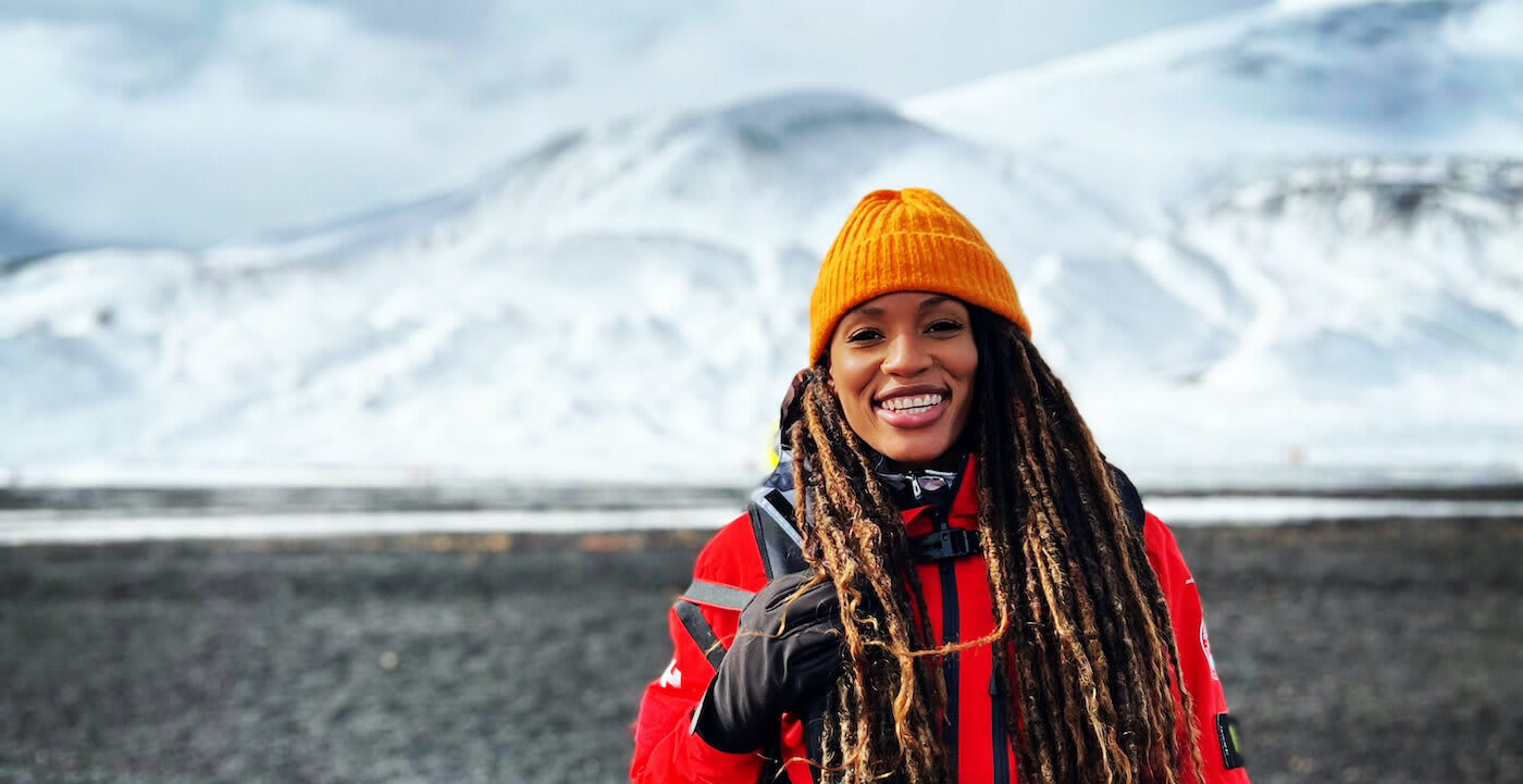 martinique lewis poses in front of a mountain range