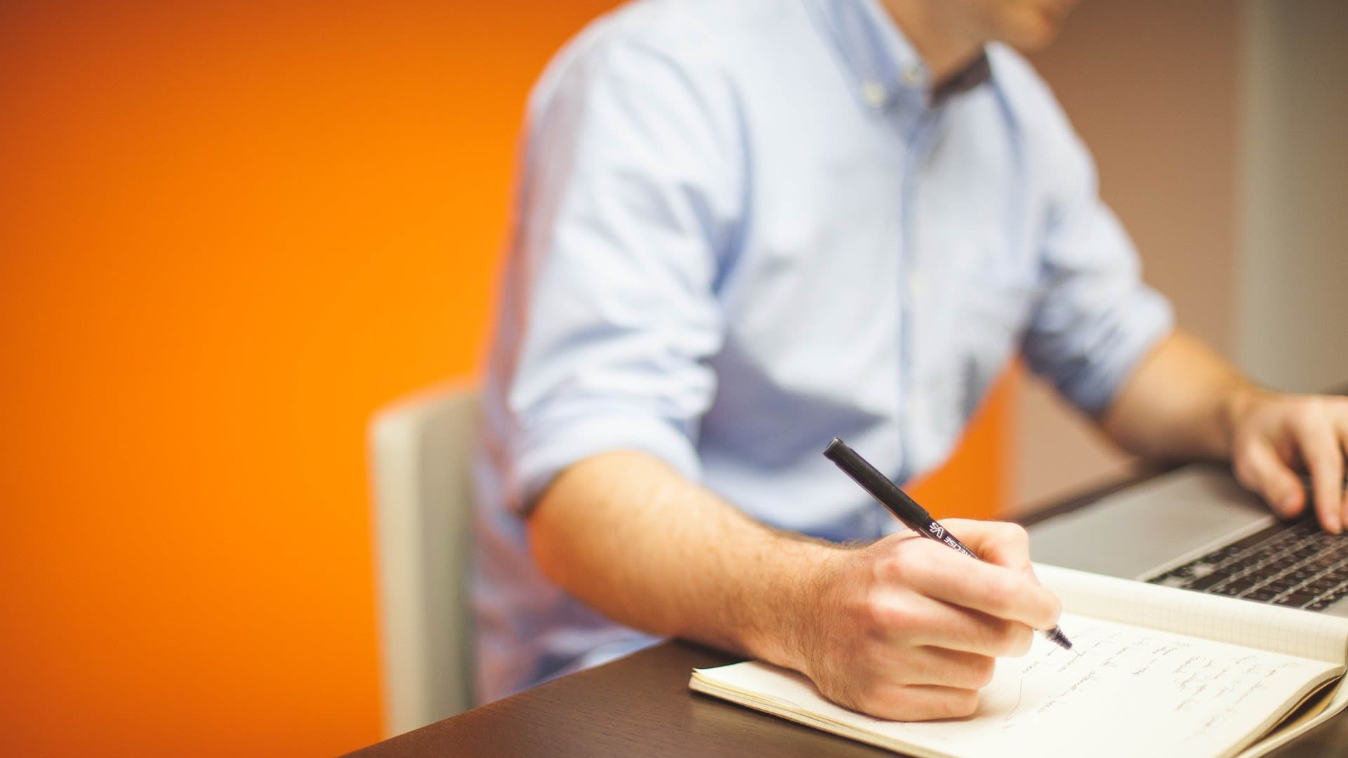 Man writing in notebook