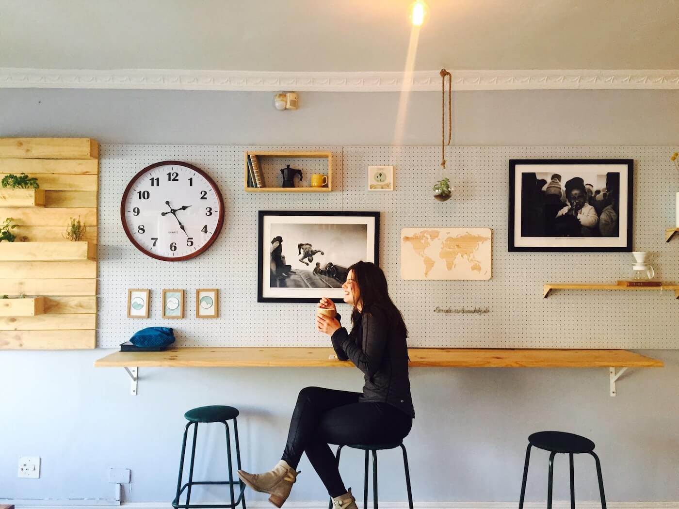 a woman sits in a cafe with a coffee