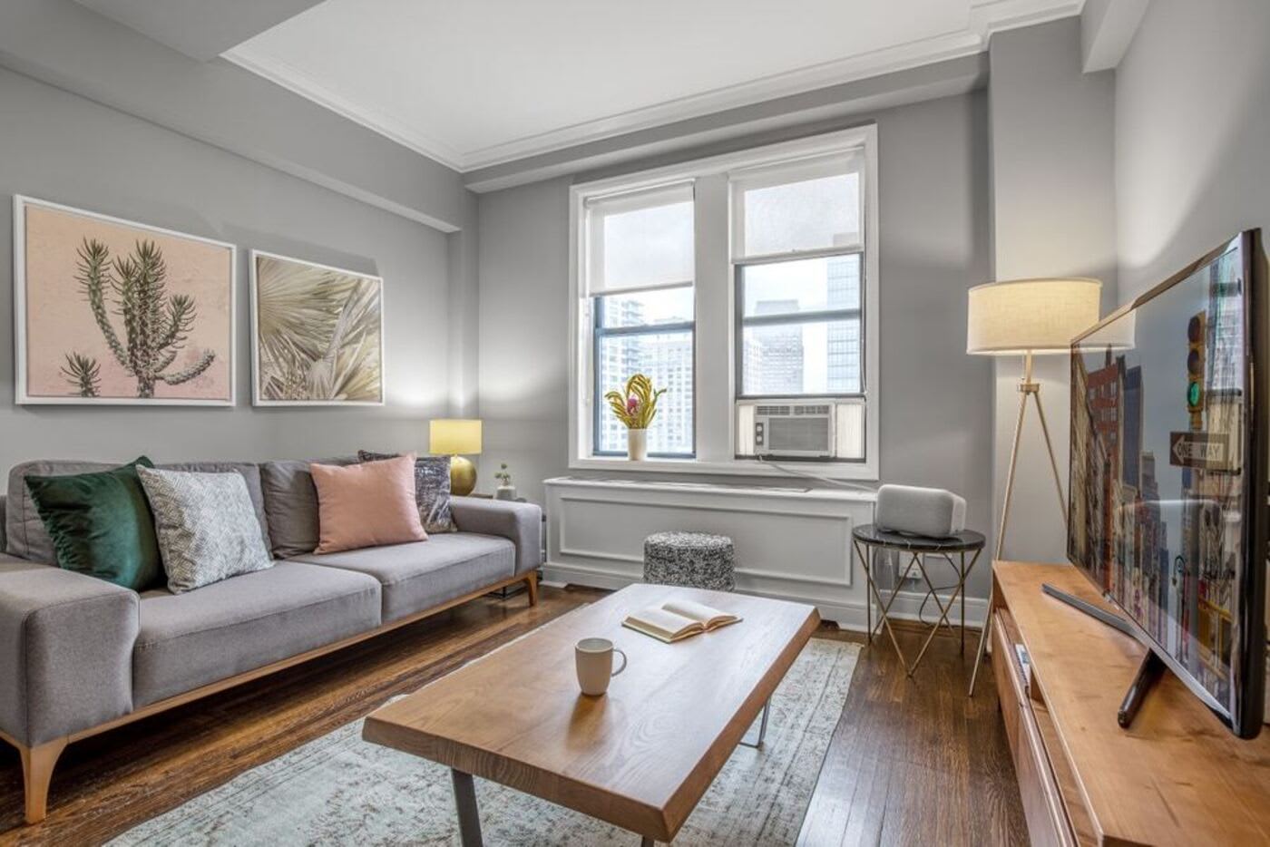 blueground Columbia Off Campus Housing Off Campus Housing NYU apartments near NYU neutral color themed living room with cactus print on wall