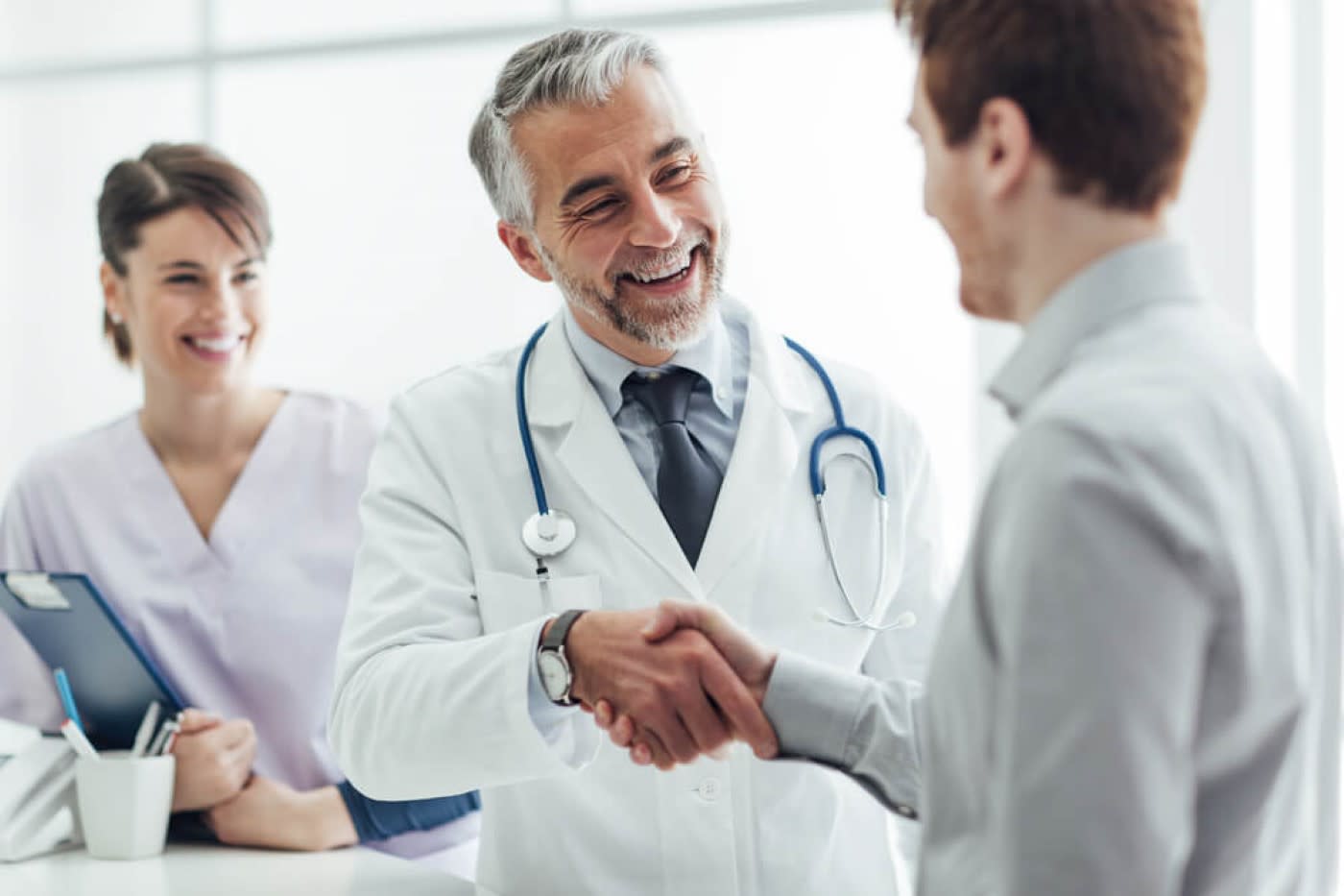 doctor and nurse greeting a patient