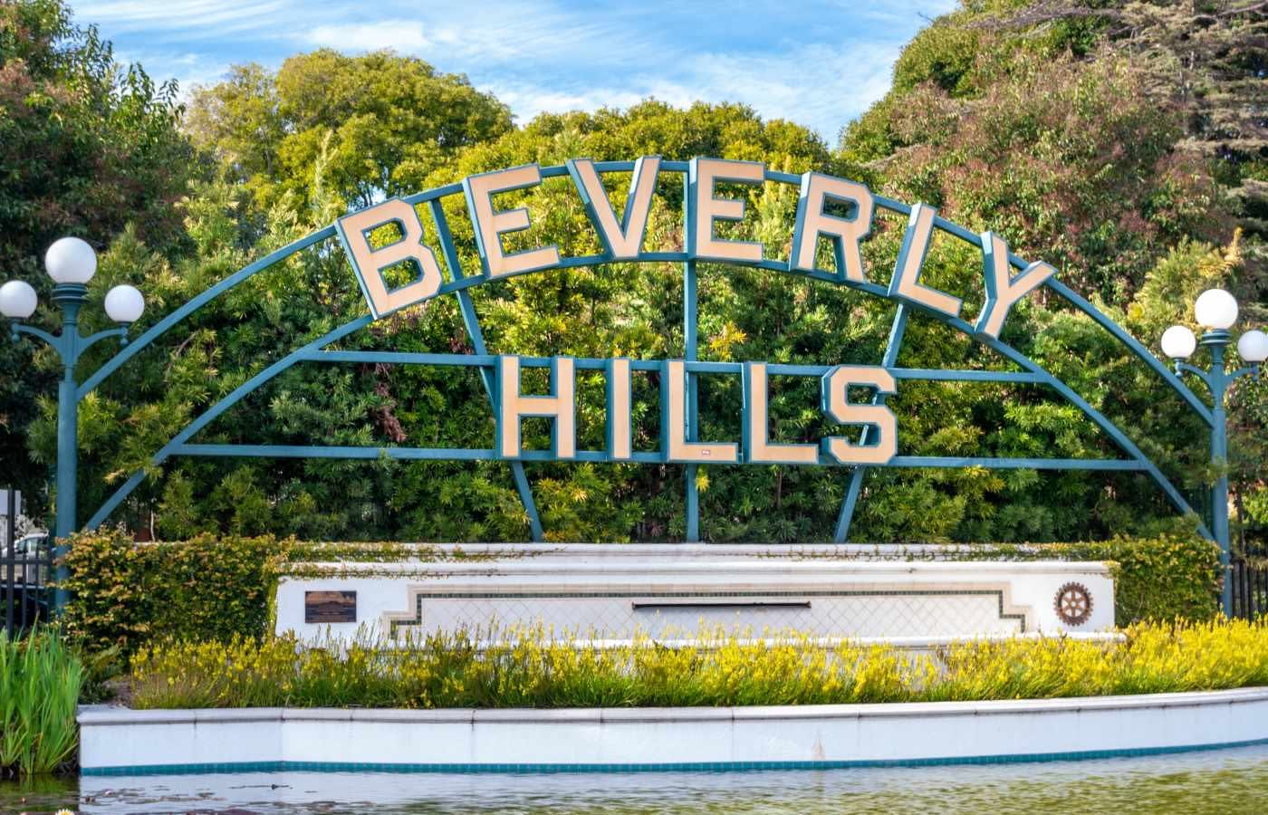 An arched metal sign reading "Beverly Hills".