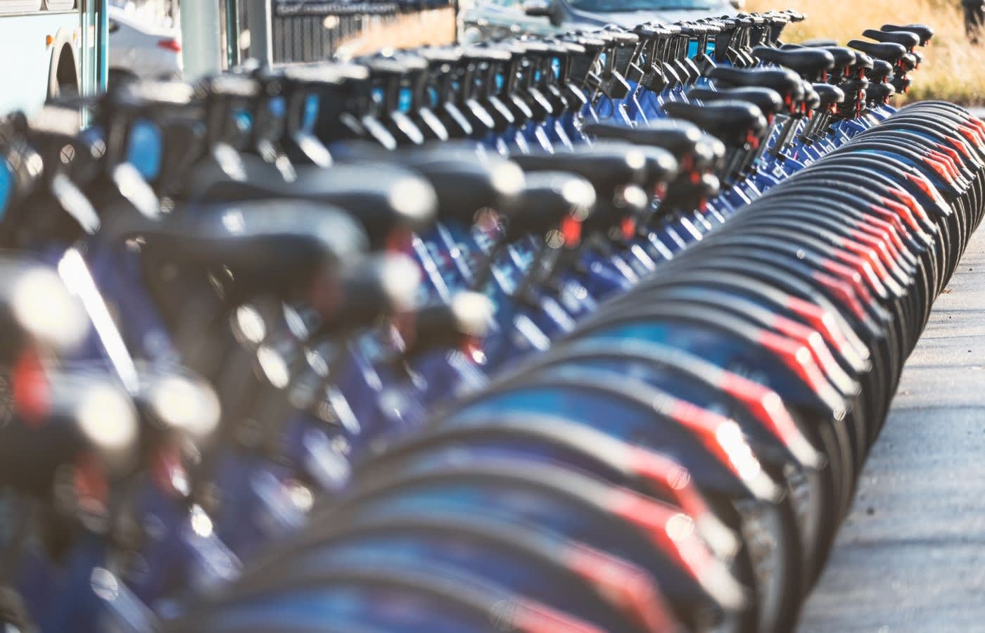 A row of rental bikes locked in their stations.