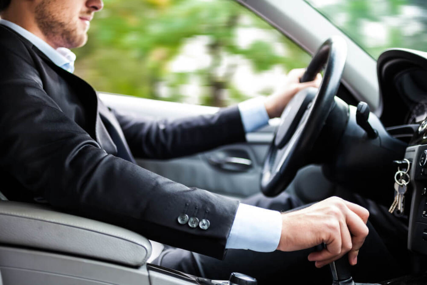 carshare in San Francisco man wearing a business suit driving a car rented using his phone