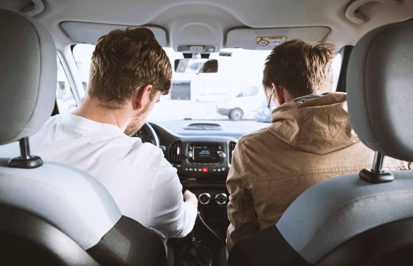 Two people in the front seats of a car