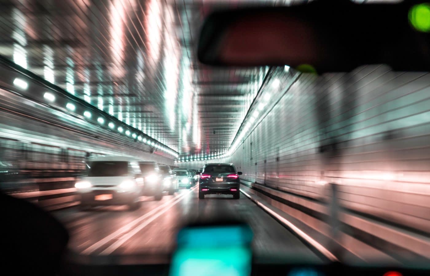 A photo from inside a car driving in a tunnel in new york.