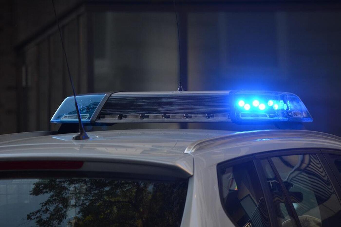 A police patrol car with the blue lights turned on