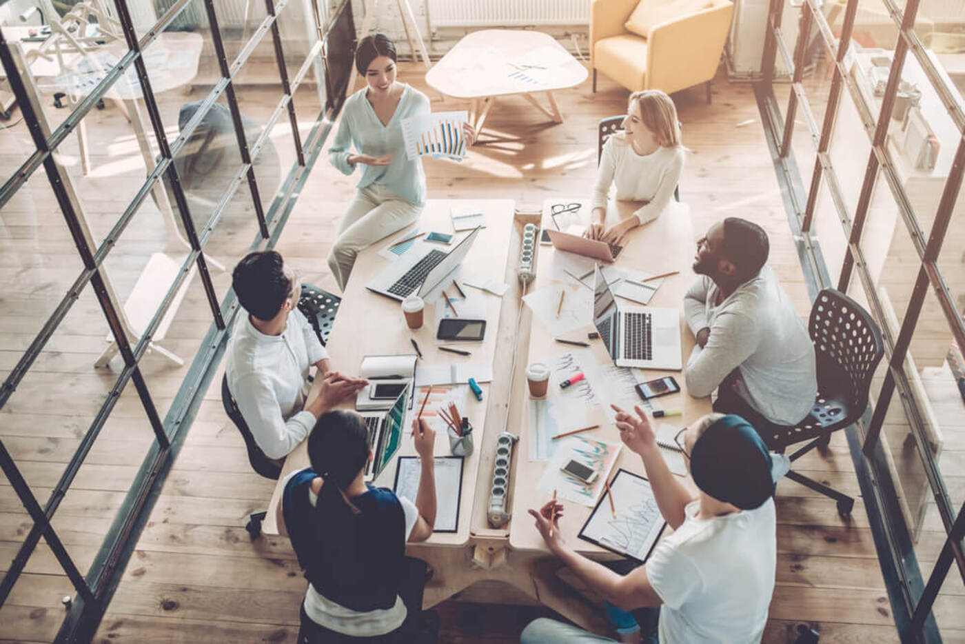 coworking spaces in seattle group of 6 team members inside a conference room discussing a project