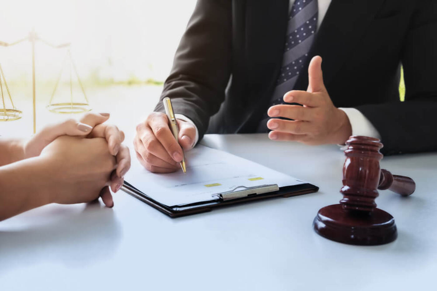 man sits with a lawyer to discuss how to file a lawsuit