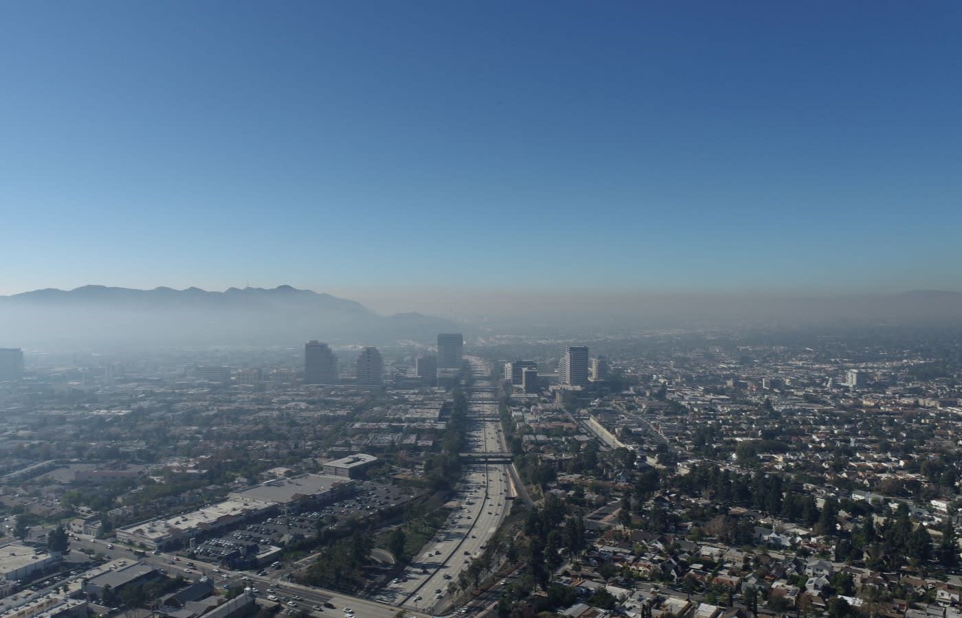 A large highway with tall buildings on either side in Glendale, California.