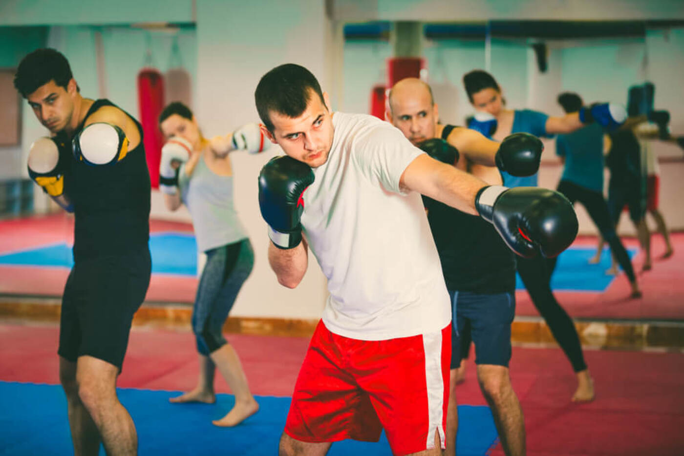 gyms in DC men and woman practicing a jab punch in boxing class