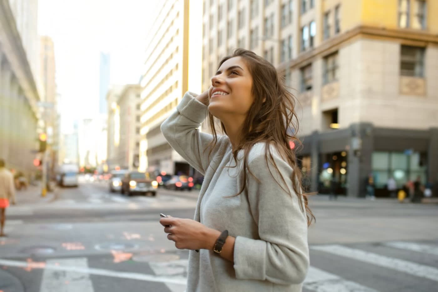Woman gazing up to a building from a crosswalk