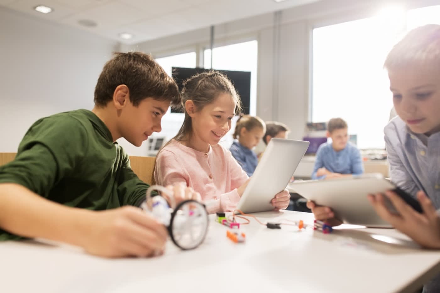 group of happy students with tablet pc computer programming