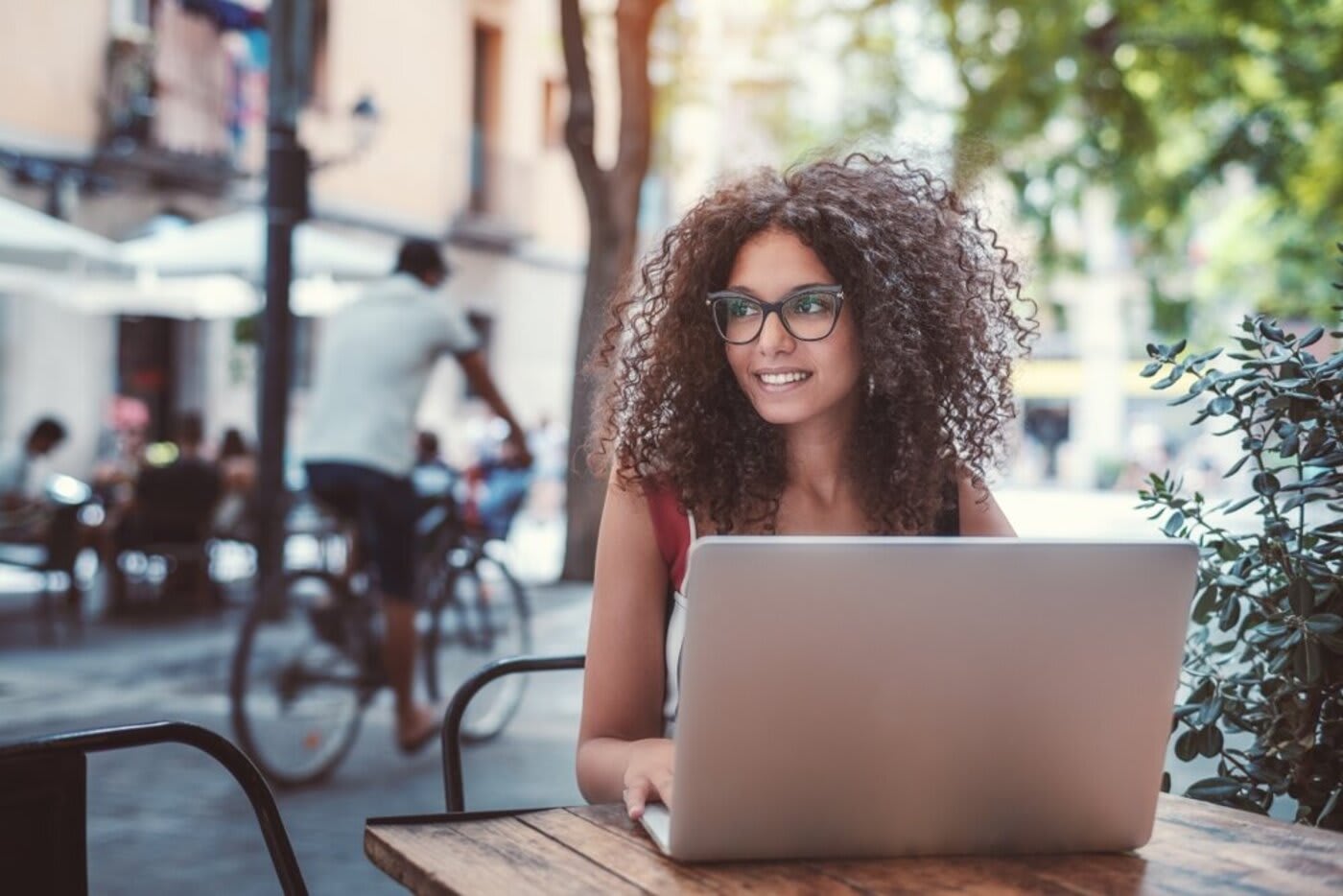 woman sitting in the outdoors in front of her laptop