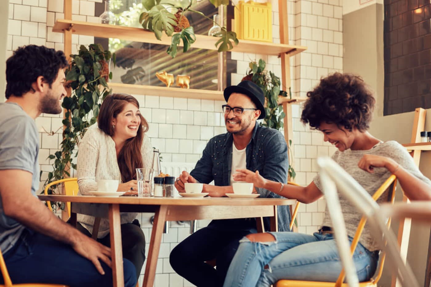 a group of four friends meeting at a coffee shop