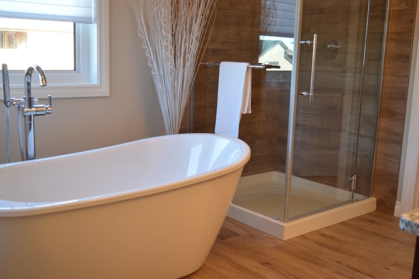 Clean bathroom with a white tub and shower