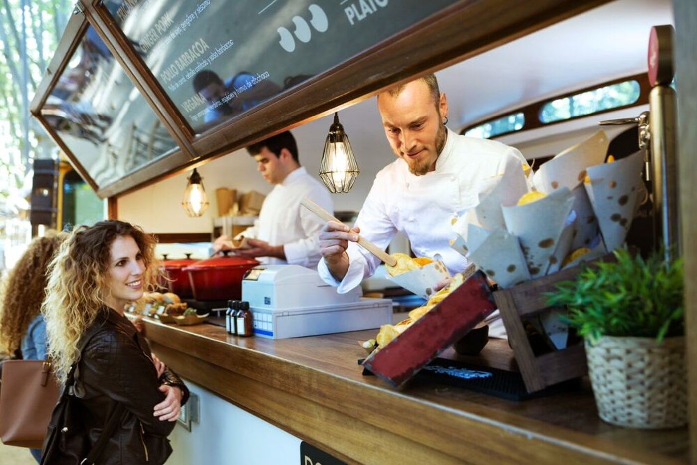 San Francisco apps woman purchasing a meal from a cook on a food truck