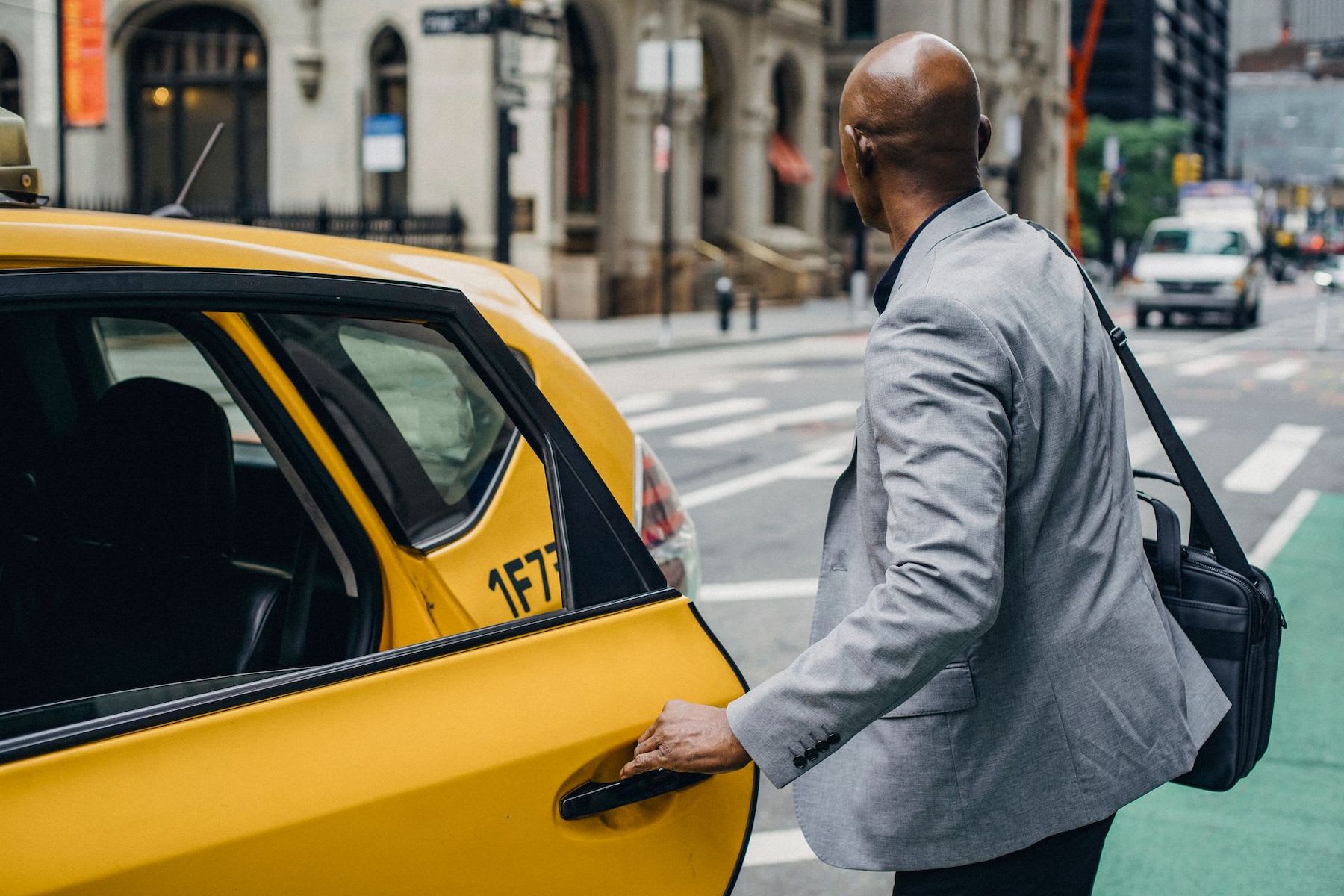 business traveller getting in taxi