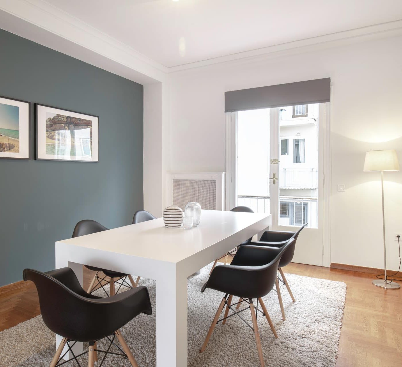 dining room with dining set on grey fur carpet black chairs and white table between green and white walls