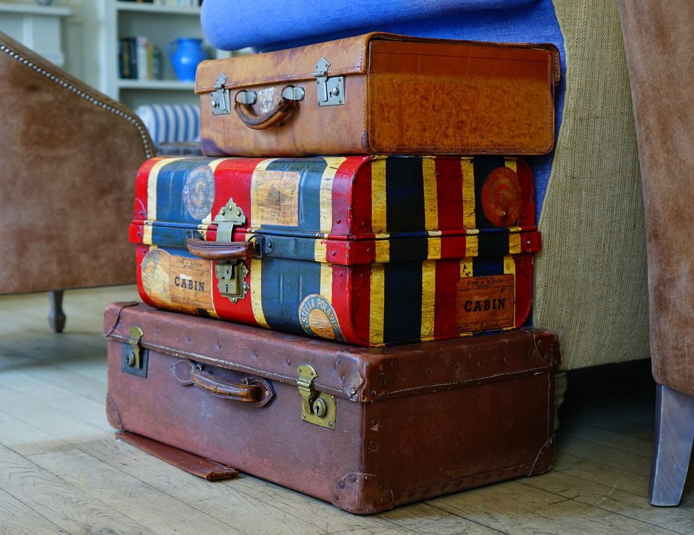 luggage shipping three different colored suitcases stacked on top of each other