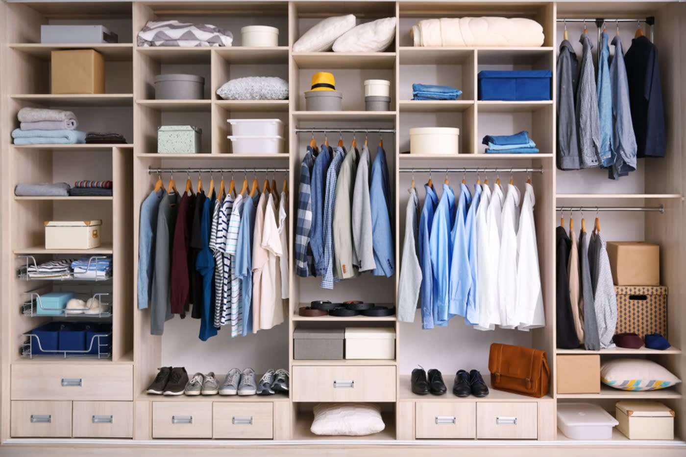 minimal open closet with hanged shirts and lots of organization boxes
