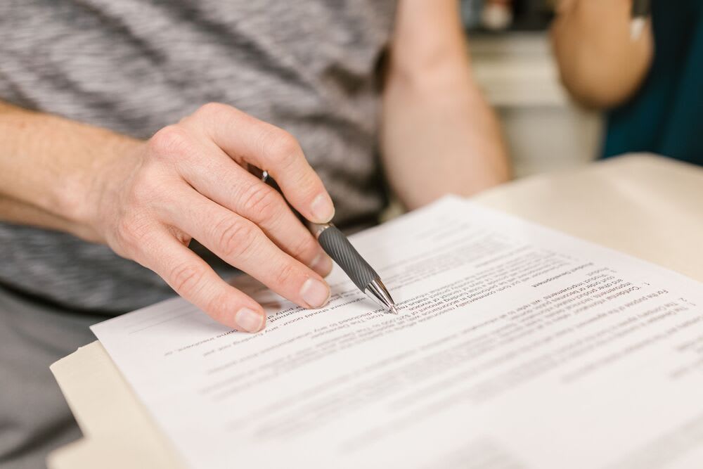 employee signing a corporate housing agreement document