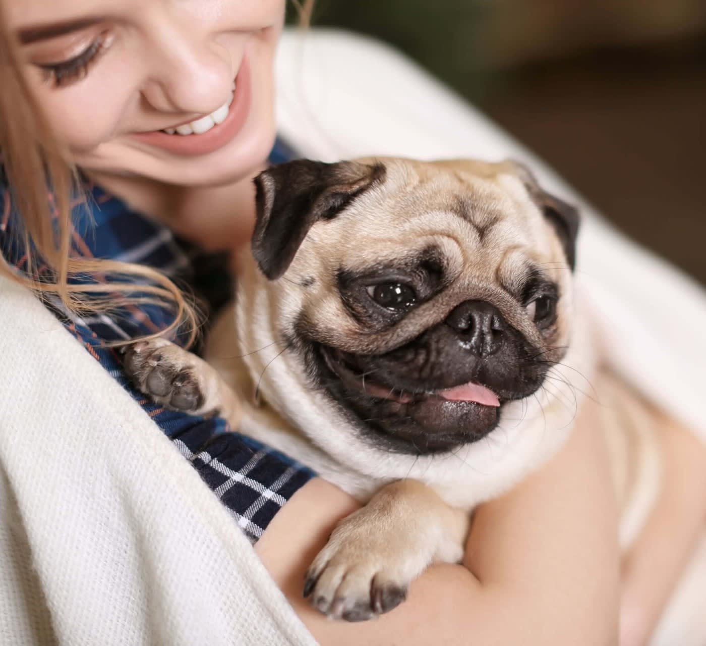 woman hugging her pug