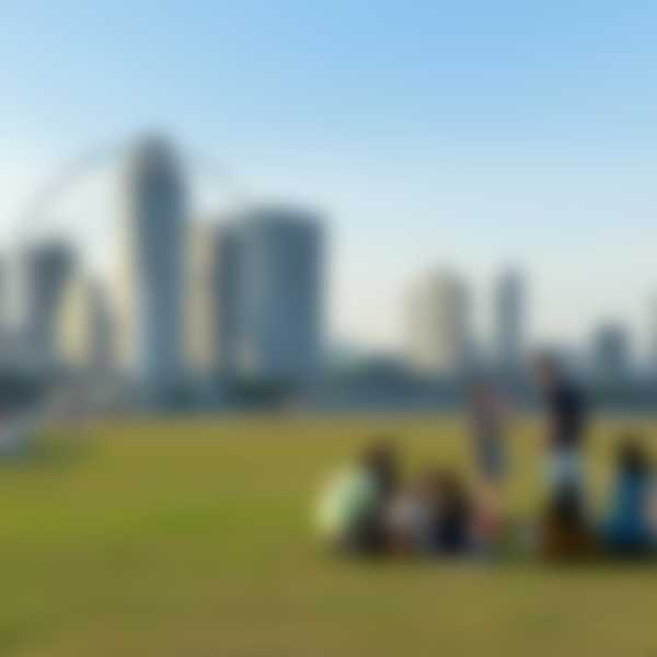 Group of friends in Singapore enjoying a green space in front of the skyline