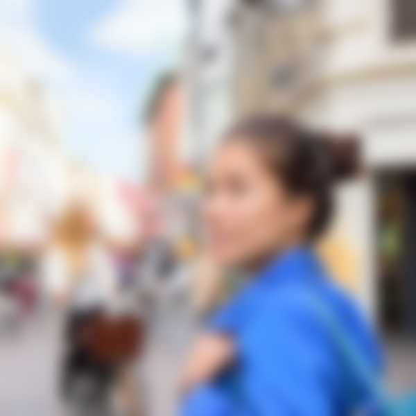 Woman on a European street looking around