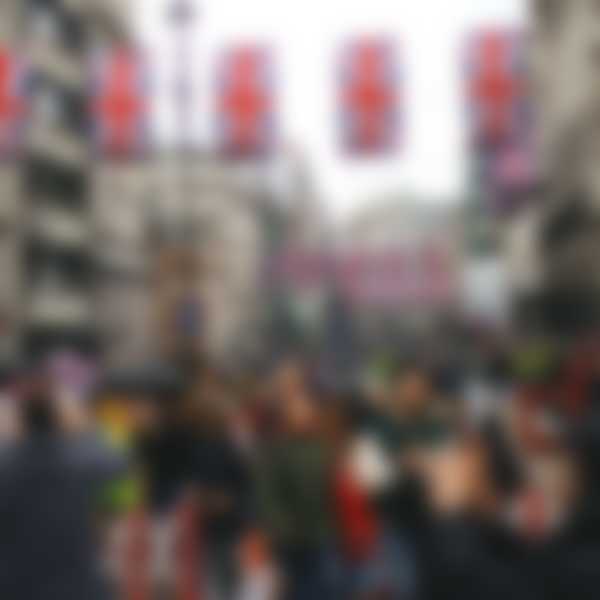 Crowd in London at Piccadilly Circus with British flags