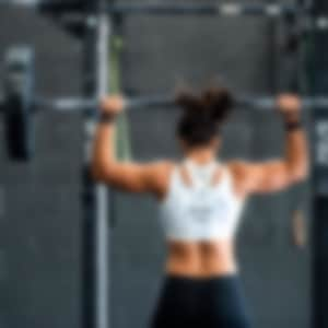 A woman lifts weights at the gym