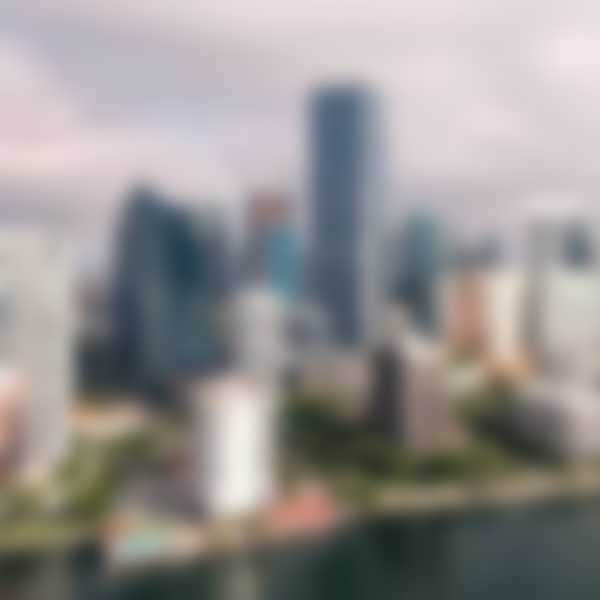 An aerial view of downtown miami. Skyscrapers are seen near the city waterfront.