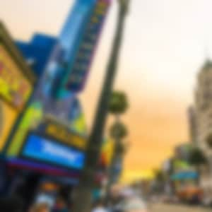 Hollywood Californi at sunset with an orange sky above buildings and lights