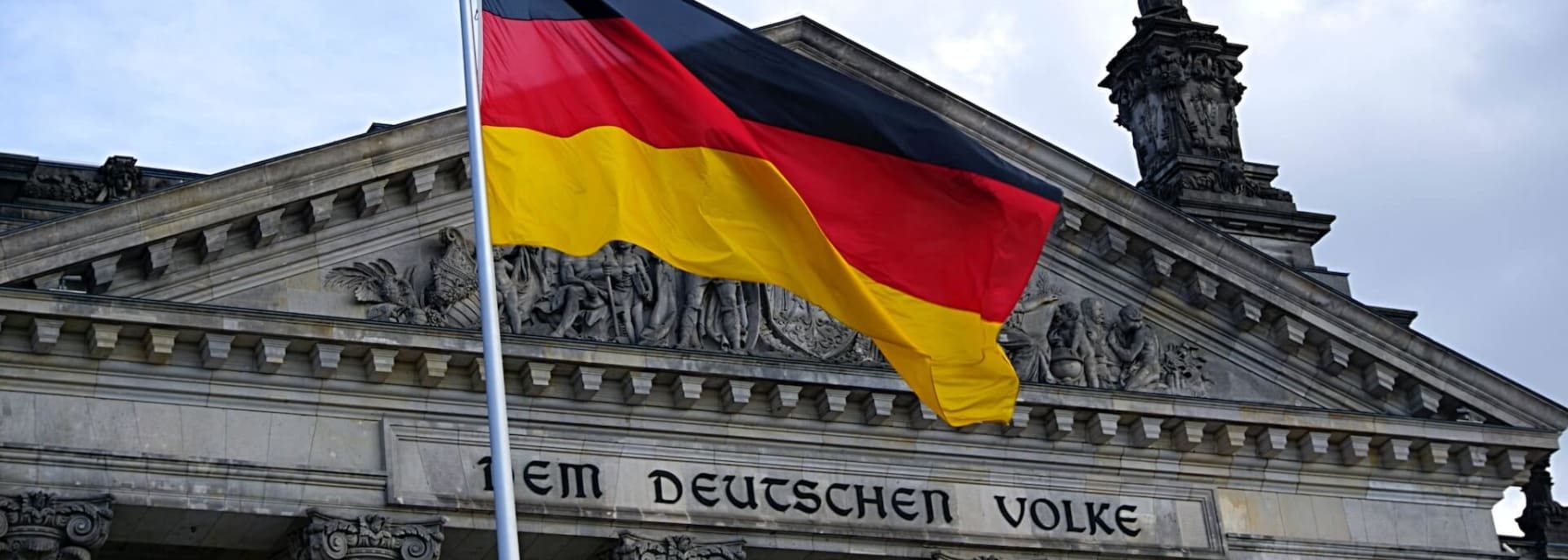 German flag in front of the Reichstag building in Berlin