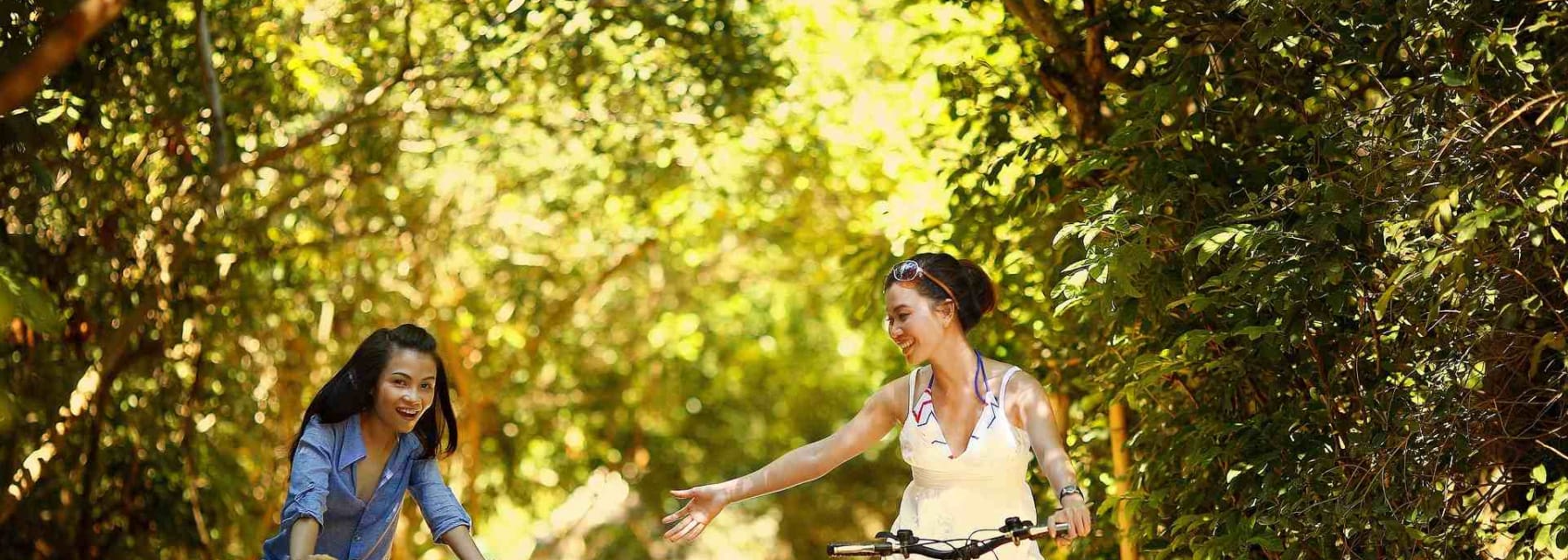 Two girls on bikes in forest