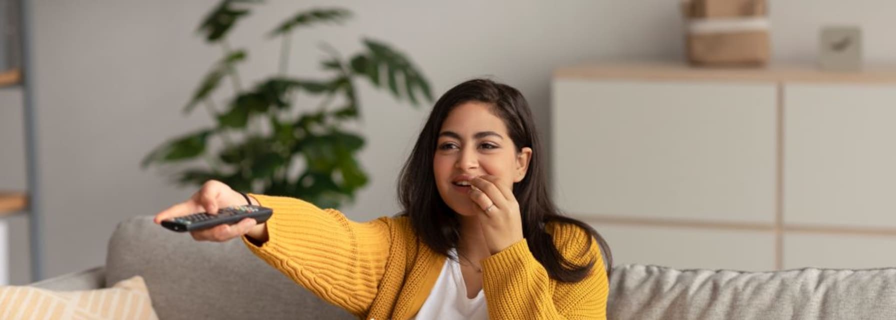 Woman watching TV with popcorn