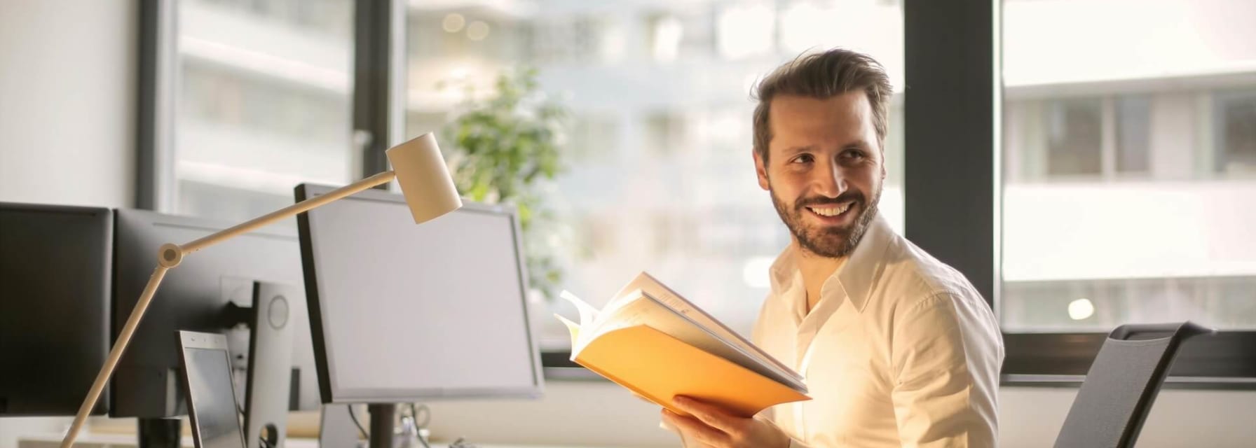 Business man sitting and smiling at a desk