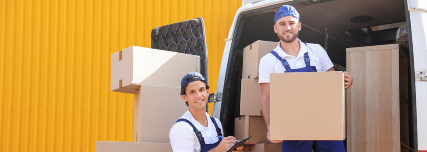 two men working for a Chicago moving company taking boxes from the moving van