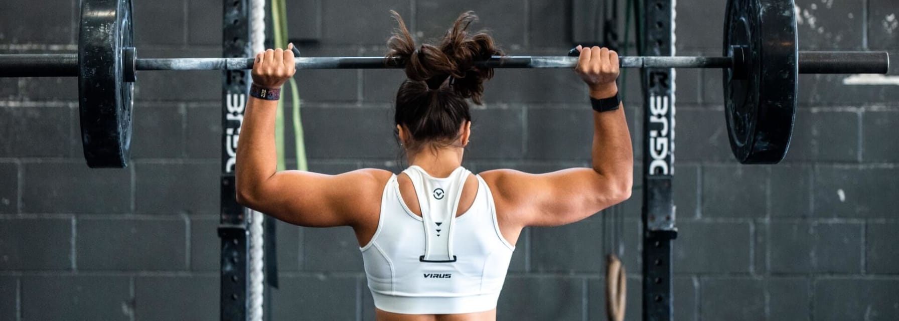 A woman lifts weights at the gym